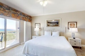 Relax in comfort with a large bed, bedside tables, and a window offering a view of the outdoors.