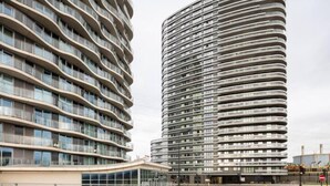 Two modern high-rise buildings with curved balconies and large windows. - Remarkable 2-bed Apartment in London Amazing Views (London)