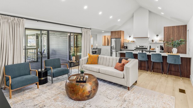 A modern living room with a sofa, chairs, and a coffee table.
