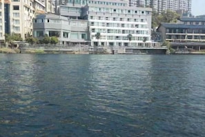 A waterfront hotel with multiple floors, a dock, and a view of the water. - Guorui Hotel (Jiande)