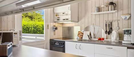 Fridge, stovetop, dishwasher, coffee/tea maker