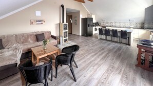 A cozy loft apartment with a living area, kitchenette, and dining space. - Cozy apartment in Jelesnia with WiFi (Jelesnia)