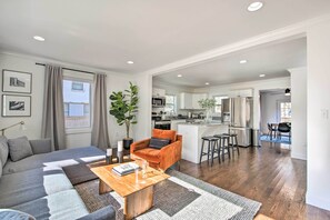 Relax in this open-plan living space with a large sectional sofa, coffee table, and armchair.