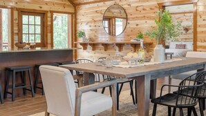 A wooden interior with a dining table, chairs, and a bar area. - Ridge View by Avantstay15mins From Pigeon Forge w/ Pavilion, Indoor Pool & Hot Tub! (Sevierville)
