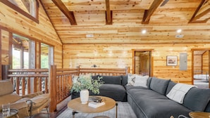 A wooden cabin interior with a sofa, a round table, and a balcony. - Ridge View by Avantstay15mins From Pigeon Forge w/ Pavilion, Indoor Pool & Hot Tub! (Sevierville)