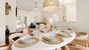 Enjoy meals in this stylish dining area with a long oval table, woven placemats, and comfortable seating.