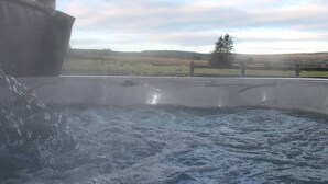 A hot tub with a view of a rural landscape. - Forest View House - Private Hot Tub (Coleraine)