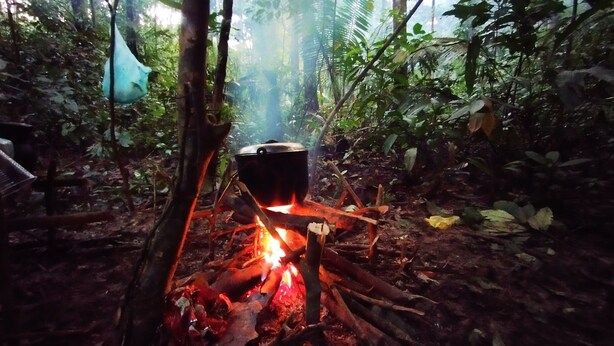 A pot over an open fire in a forested area. - Authentic Amazon | Indigenous Lodging and Jungle Tours (Loreto Mocagua)