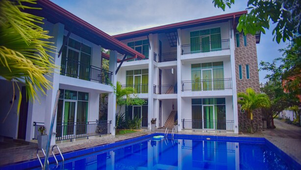 A multi-story hotel with a swimming pool, balconies, and a garden area. - Shiromi Hotel Katunayaka (Seeduwa - Katunayake)