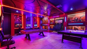 A gaming room with pool tables, a Spiderman-themed wall, and LED lighting. - Lakeview 9BR | Spider-Man Game Room, Pool & Spa (Kissimmee)