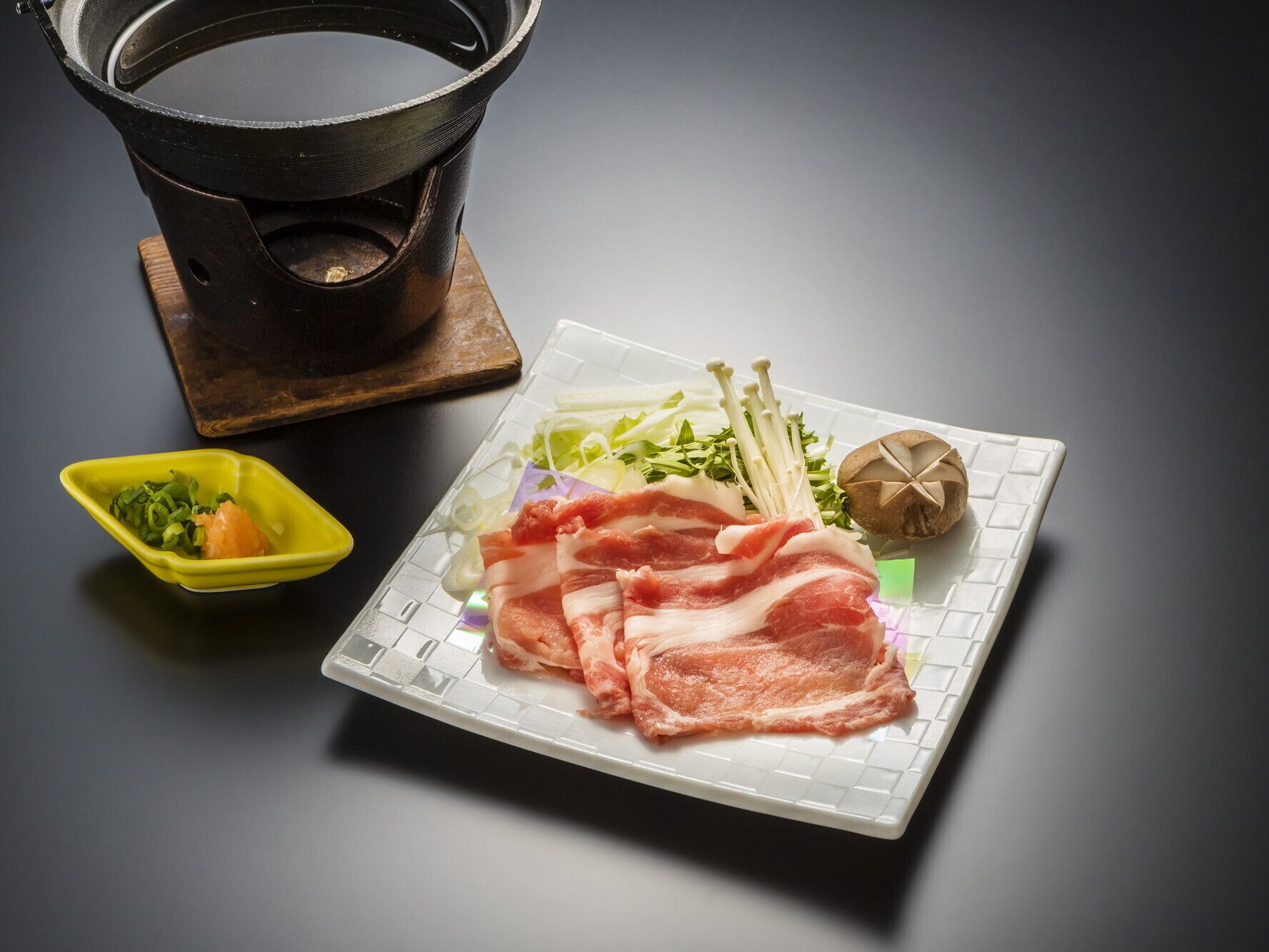 A plate with sliced meat, vegetables, and mushrooms on a white tray.
