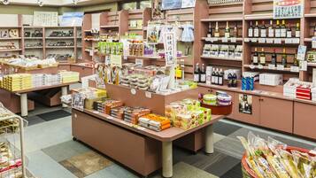 A store with various packaged goods, including snacks and beverages, displayed on shelves and counters.