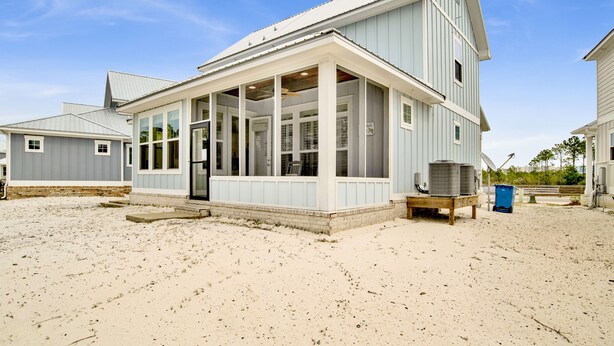 A coastal house with a large porch, a satellite dish, and a trash bin. - 3BR Home @ Summer Salt • Sleeps 13 • Porches, Pool & Near Beach (Orange Beach)