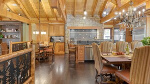 A spacious kitchen with wooden beams, a stone backsplash, and stainless steel appliances. - Moose Lodge by Avantstay Luxe Berkshires Escape (Great Barrington)