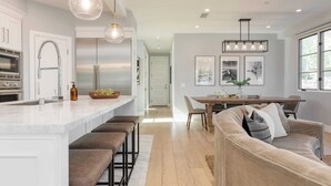 A modern kitchen with a central island, stainless steel appliances, and pendant lighting. - Sea Crown by Avantstay 5mins From the Beach w/ Multiple Terraces! Permit#slp13639 (Newport Beach)