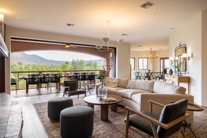 Relax in a spacious living area with a sofa set, coffee table, and dining table, leading to an outdoor terrace.