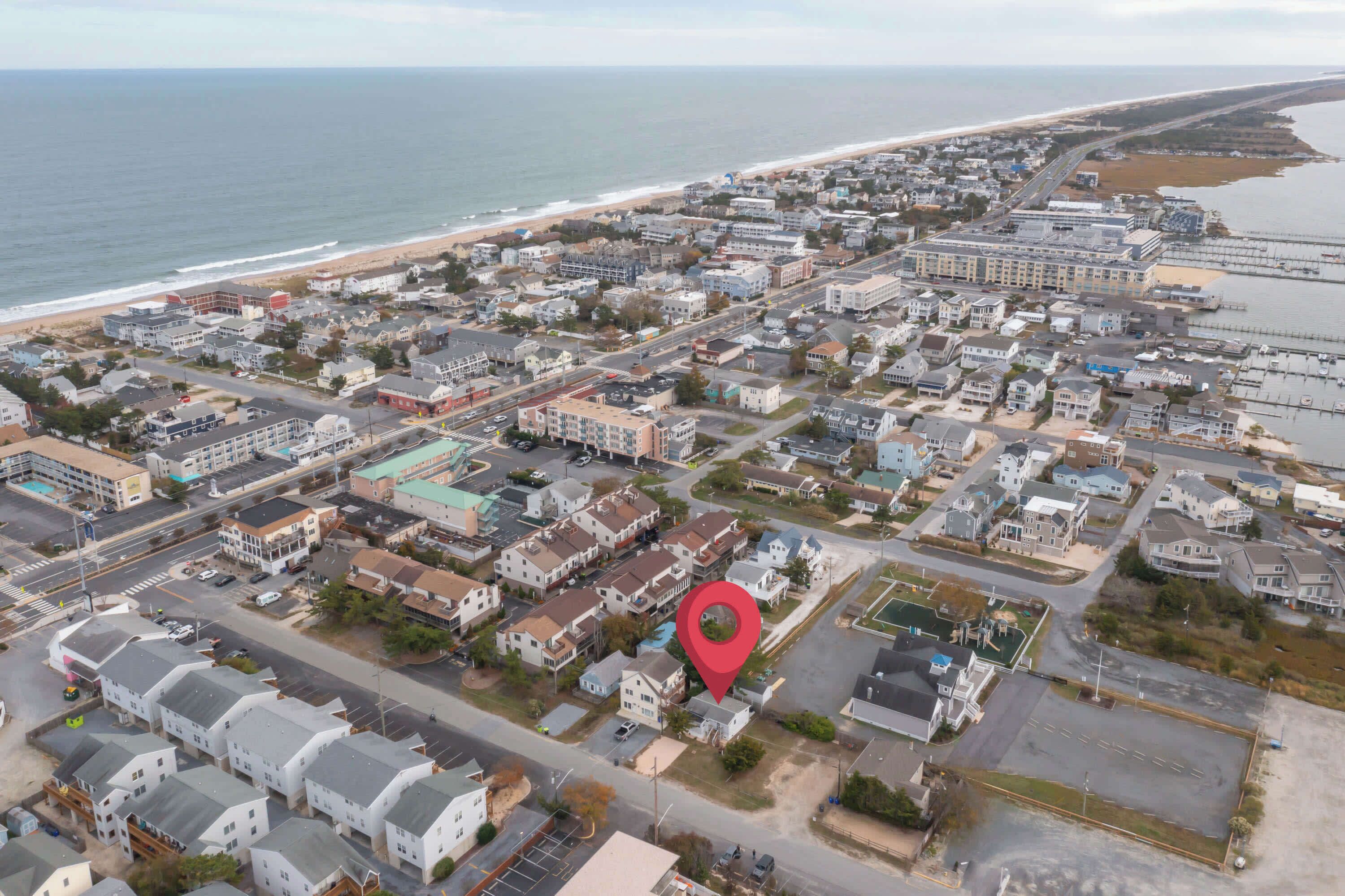 An aerial view of a coastal town with a red location marker.