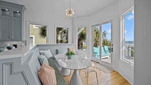 A modern kitchen with a built-in island, large windows, and a view of the outdoors. - Luxury Oceanfront- Private Pool, Hot Tub, & Elevator! Can't beat location! (Isle Of Palms)