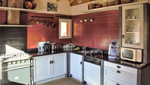 A kitchen with white cabinets, a stove, a microwave, and a dishwasher. - 2 bedroom nice home in Bidarray (Bidarray)