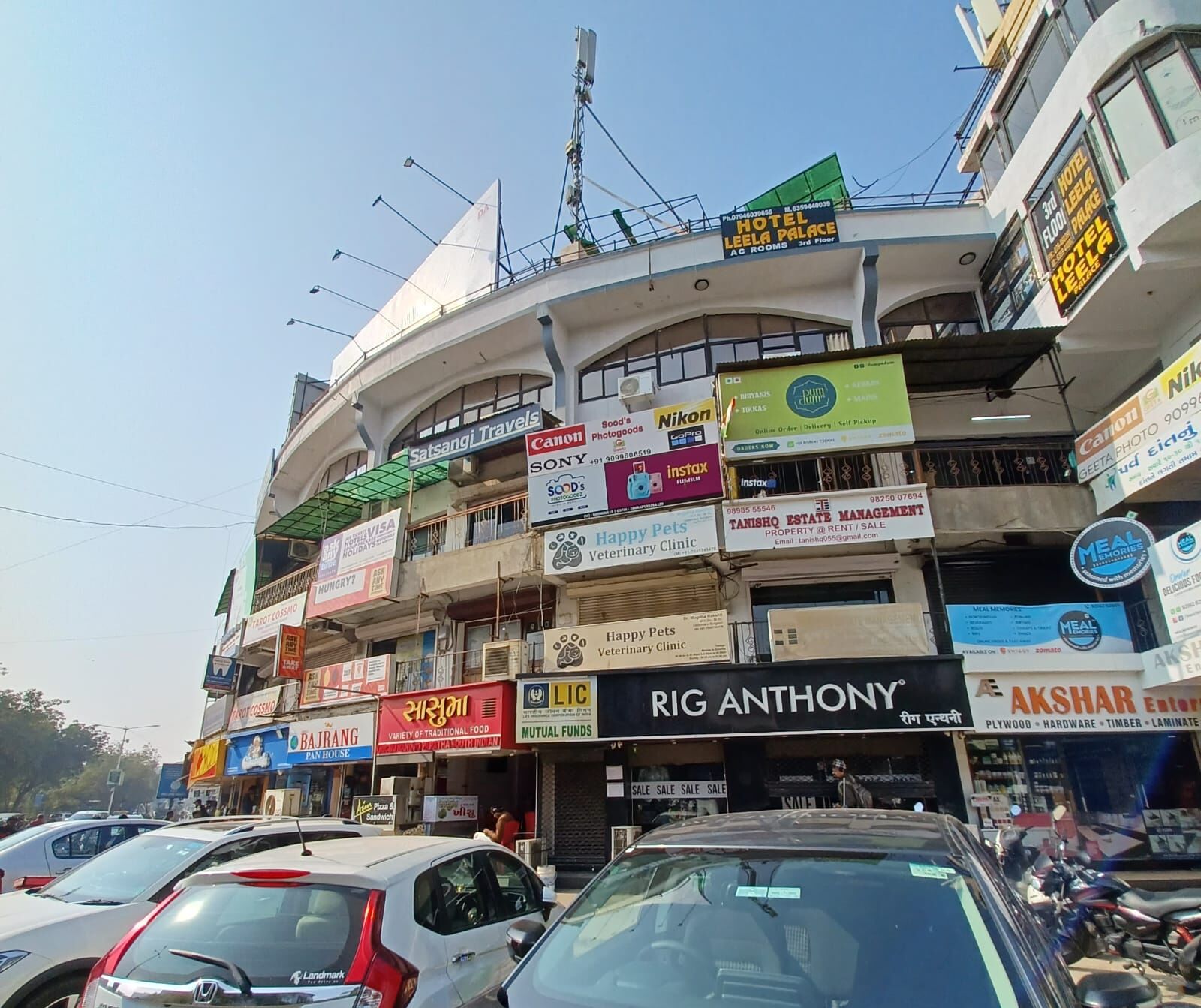 A multi-story building with various businesses including a hotel named "Hotel Leela Palace" on the 3rd floor.