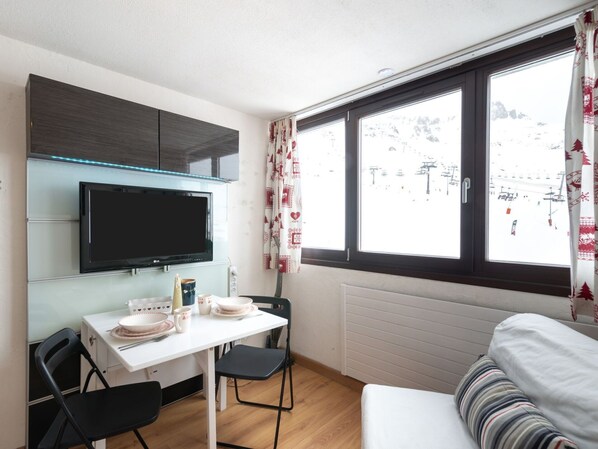 Enjoy a cozy stay with a flat-screen TV, dining area, and comfortable seating area with a view of the surrounding landscape.