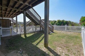 Stroll through a serene, fenced garden with a staircase leading to an upper level.