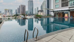 A swimming pool with a city skyline in the background. - Dua Sentral Kuala Lumpur, Roam (Kuala Lumpur)