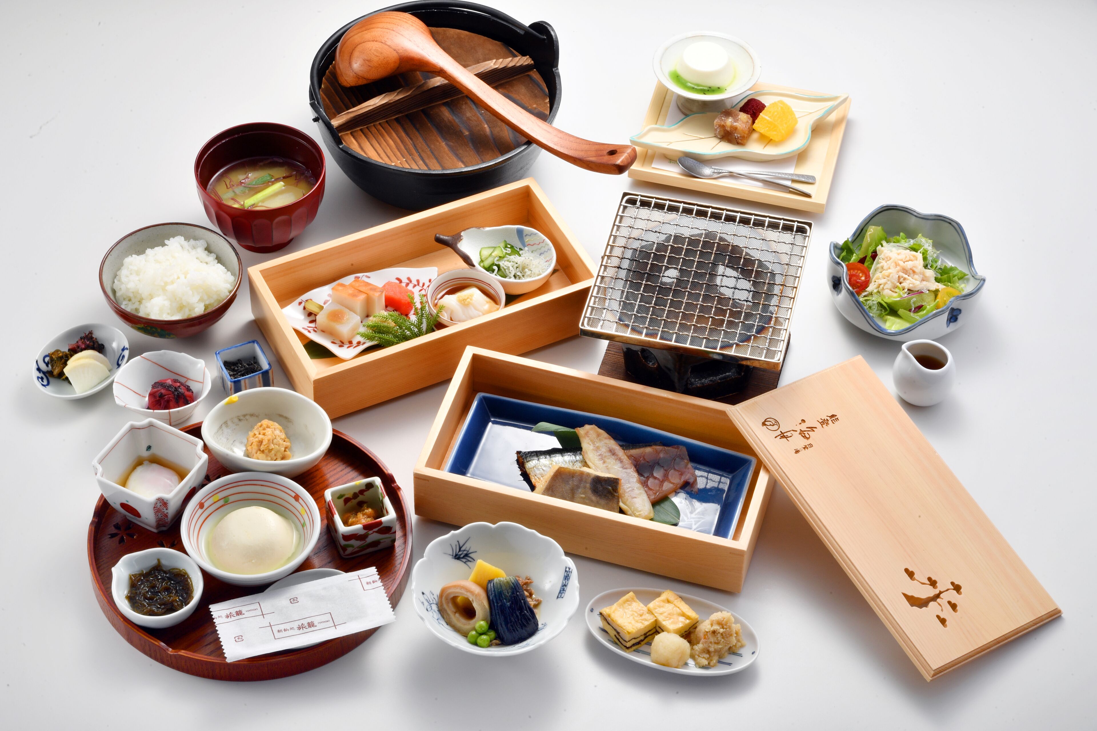 A variety of Japanese dishes including sushi, rice, and soup, arranged on a tray.
