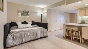 A bedroom with a bed, a desk, two stools, a lamp, and a wardrobe. - Views Overlooking Keystone w/ Shuttle to Lifts (Keystone)