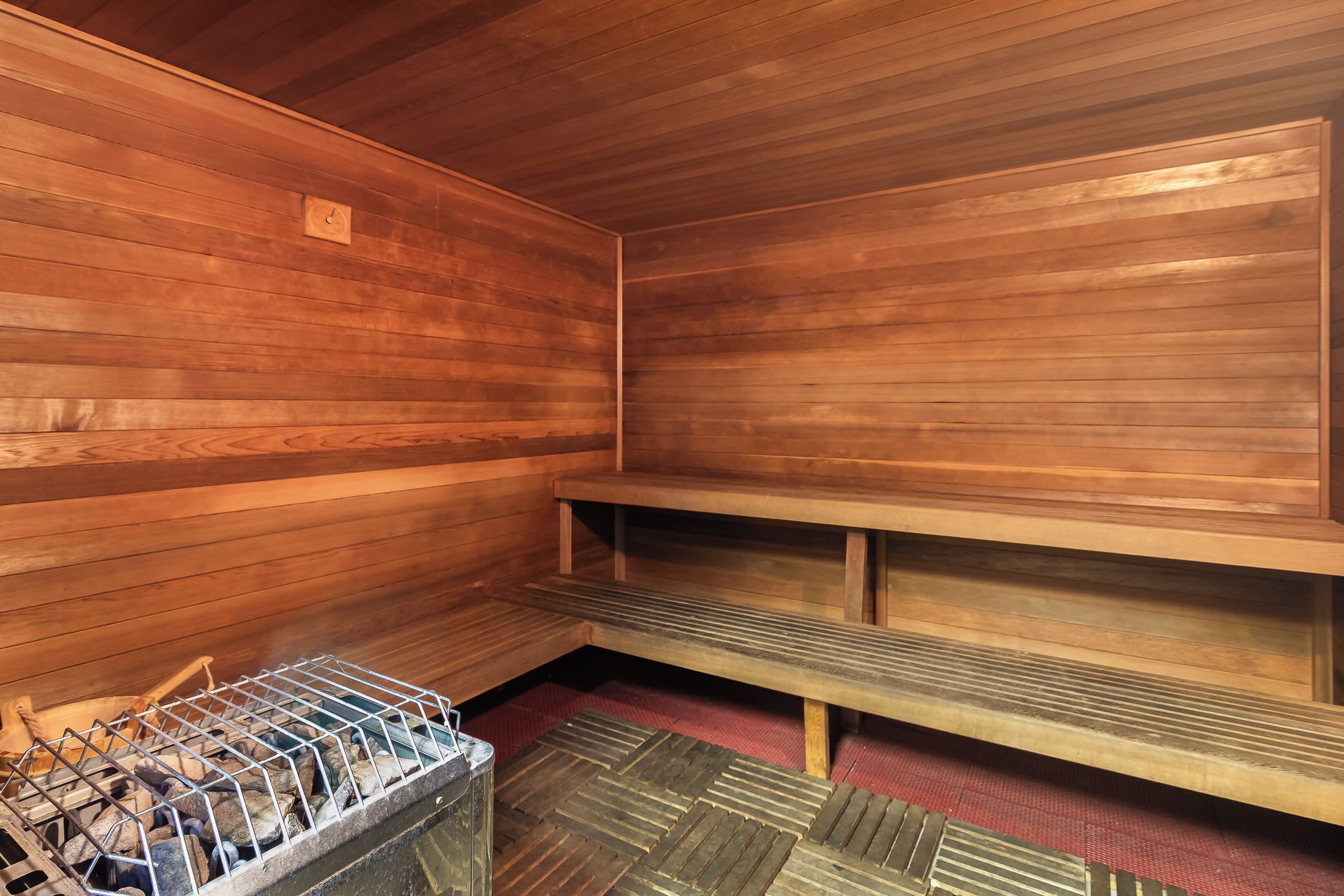 A sauna room with wooden walls and benches.