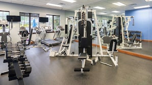 A gym with various exercise equipment, including treadmills, weight machines, and dumbbells. - Main Street in Paradise Palms (Kissimmee)