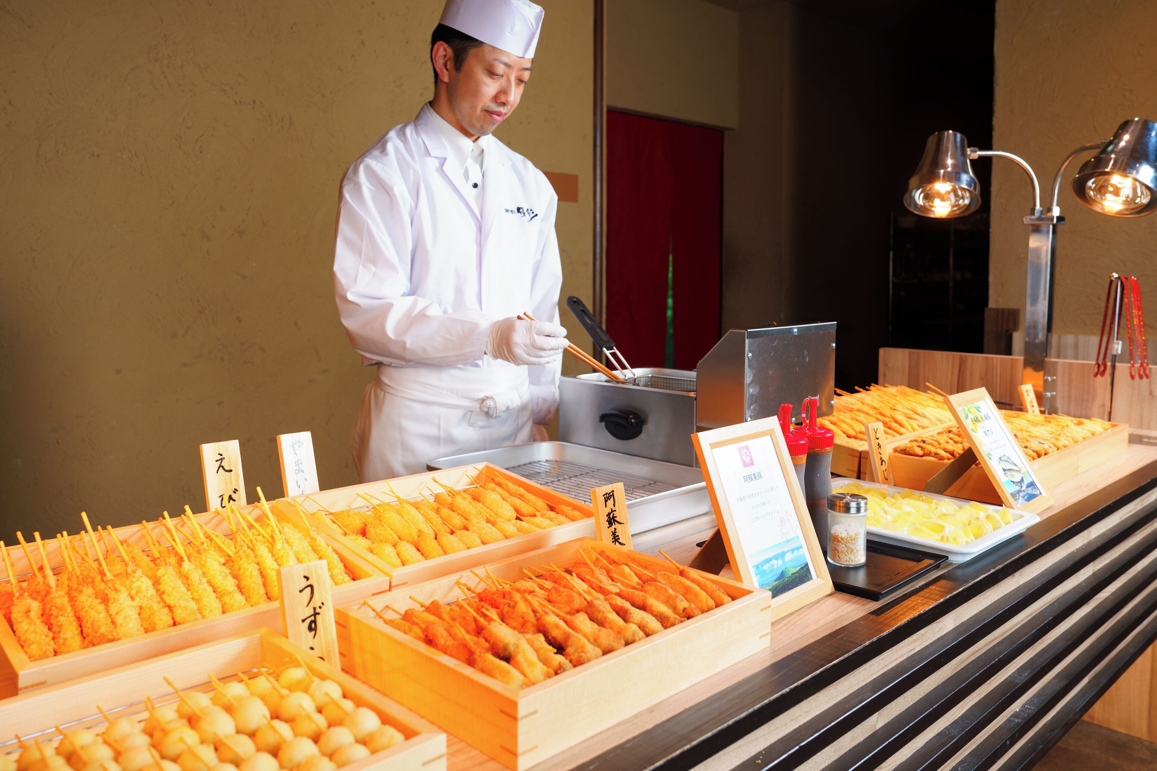 A buffet with various food items and a person serving.
