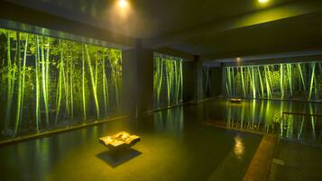 A spacious indoor area with large windows displaying a forest scene.