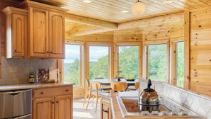 A modern kitchen with wooden cabinets, a granite countertop, and a built-in stove.