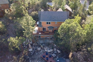 Relax on the upper-level deck amidst a serene natural setting.