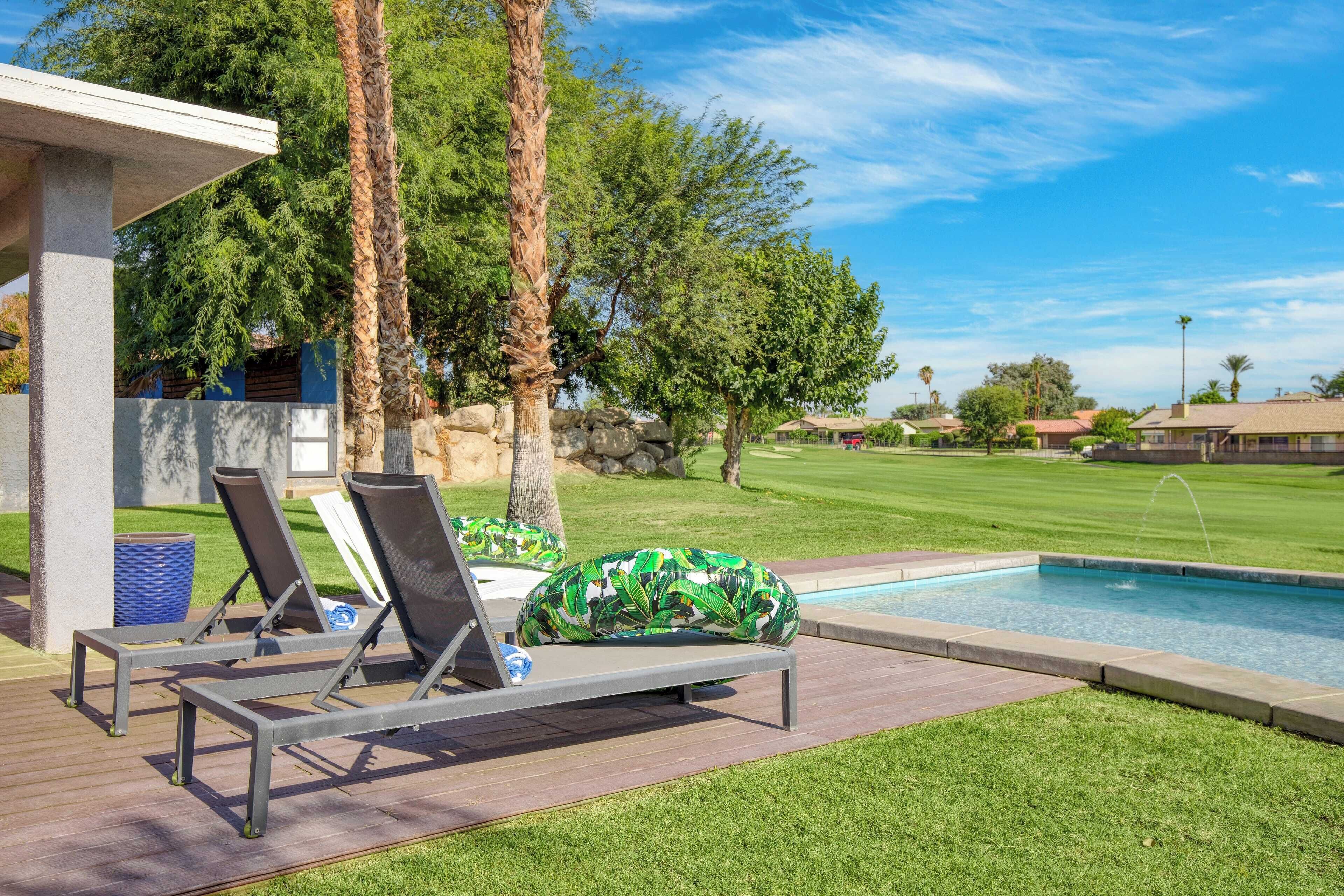 A poolside area with lounge chairs and a small pool.