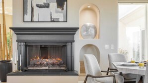 A modern living room with a fireplace, a dining area with chairs, and a large abstract painting on the wall. - Modern Temecula Mansion w Pool, Hot Tub, Guest House & Valley Views Camila by Avantstay (Temecula)