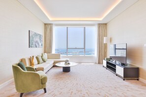 Deluxe 1BR Suite with Sea View | Living area | 55-inch Smart TV with cable channels, TV