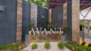 A sign with 'AVANT AT THE FORT' written in large letters, surrounded by a stone wall and plants. - ★StayHere★ 1 Bedroom Avant Fort Bonifacio BGC (Taguig)