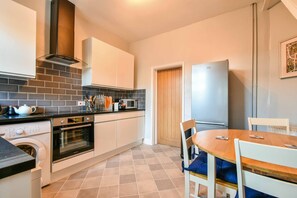Enjoy cooking in this well-equipped kitchen with an oven, microwave, and refrigerator.