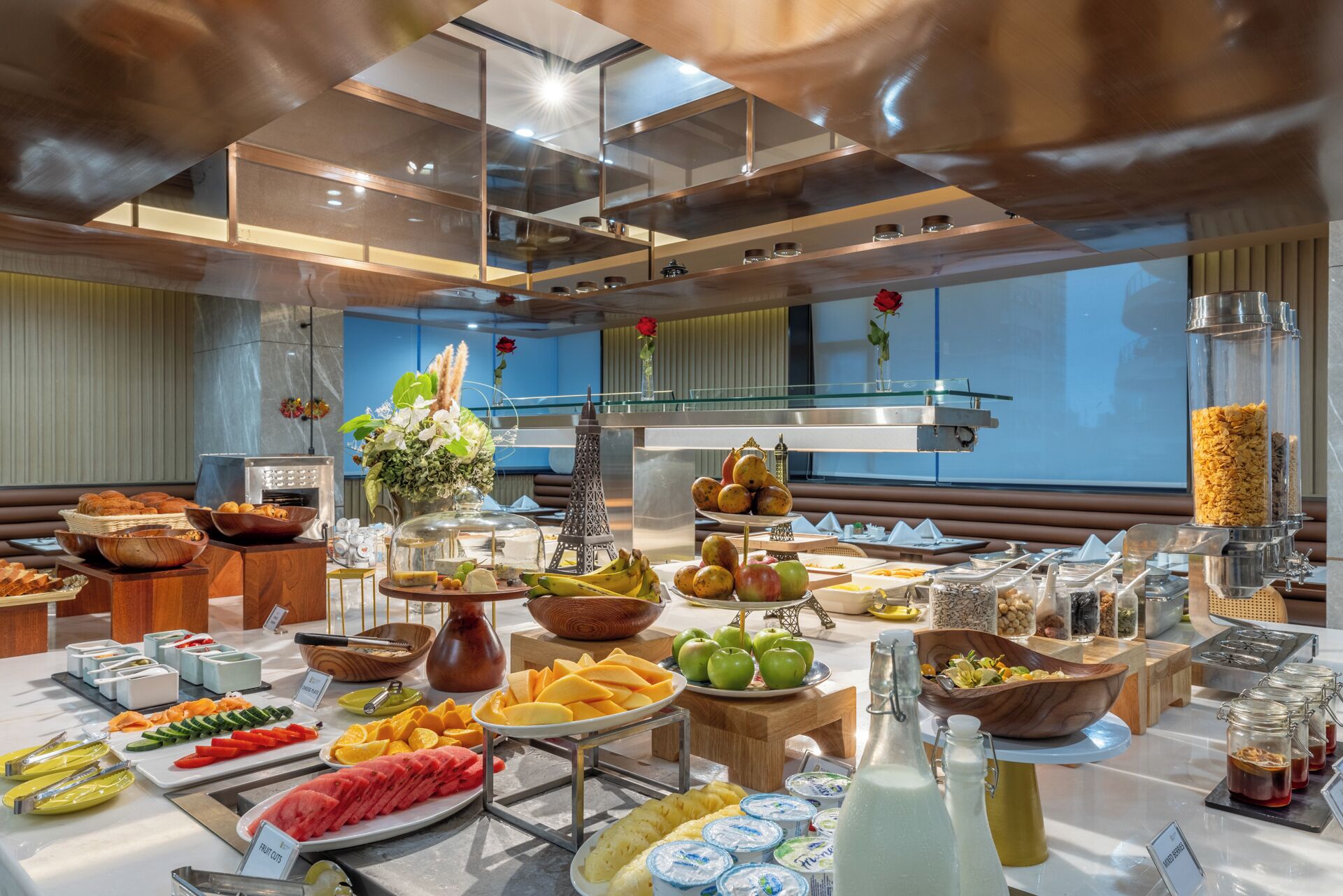 A buffet with a variety of food items, including fruits, vegetables, and dairy products.