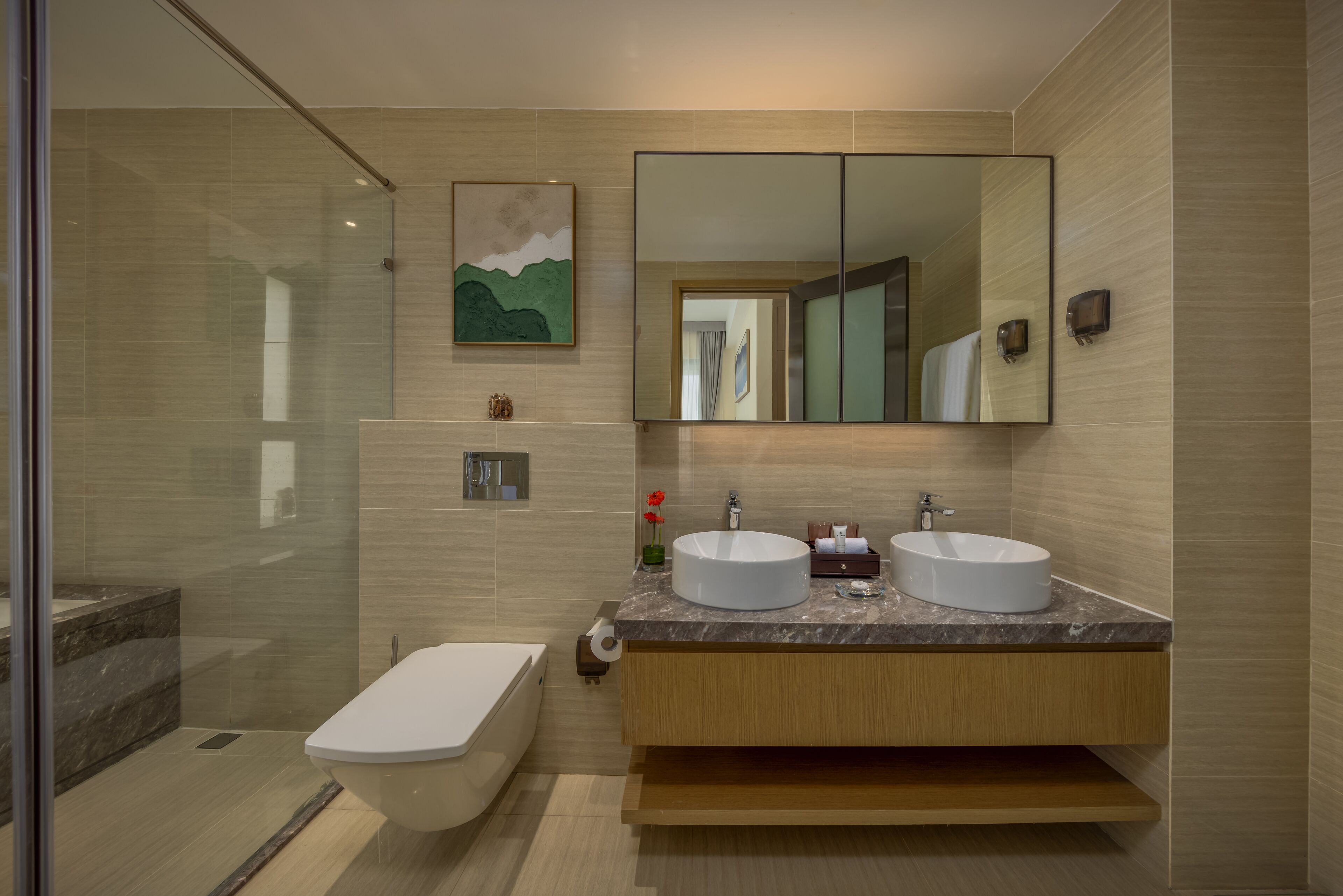 A modern bathroom with two sinks, a large mirror, and a shower area.