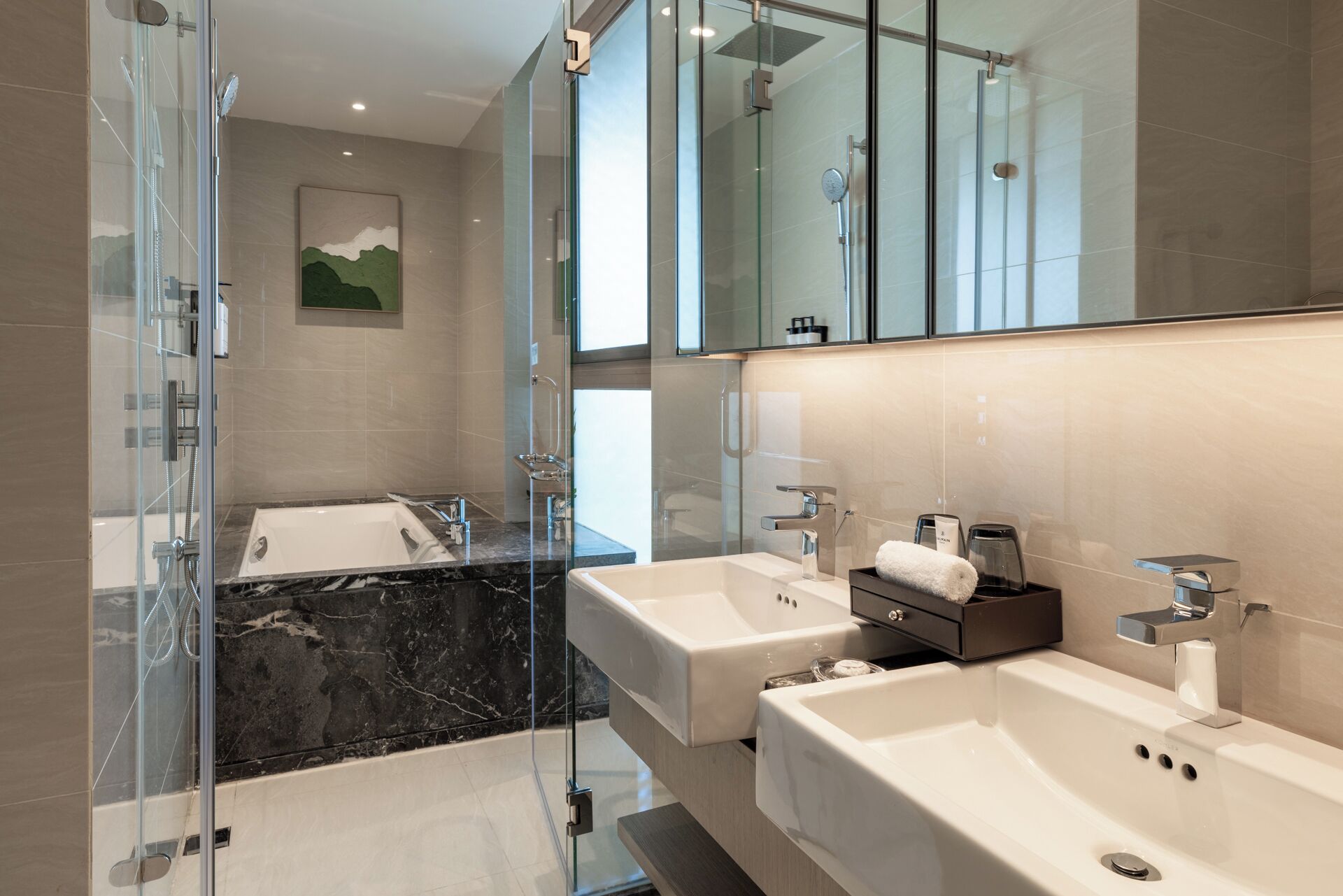 A modern bathroom with a glass-enclosed shower, two sinks, and a large mirror.