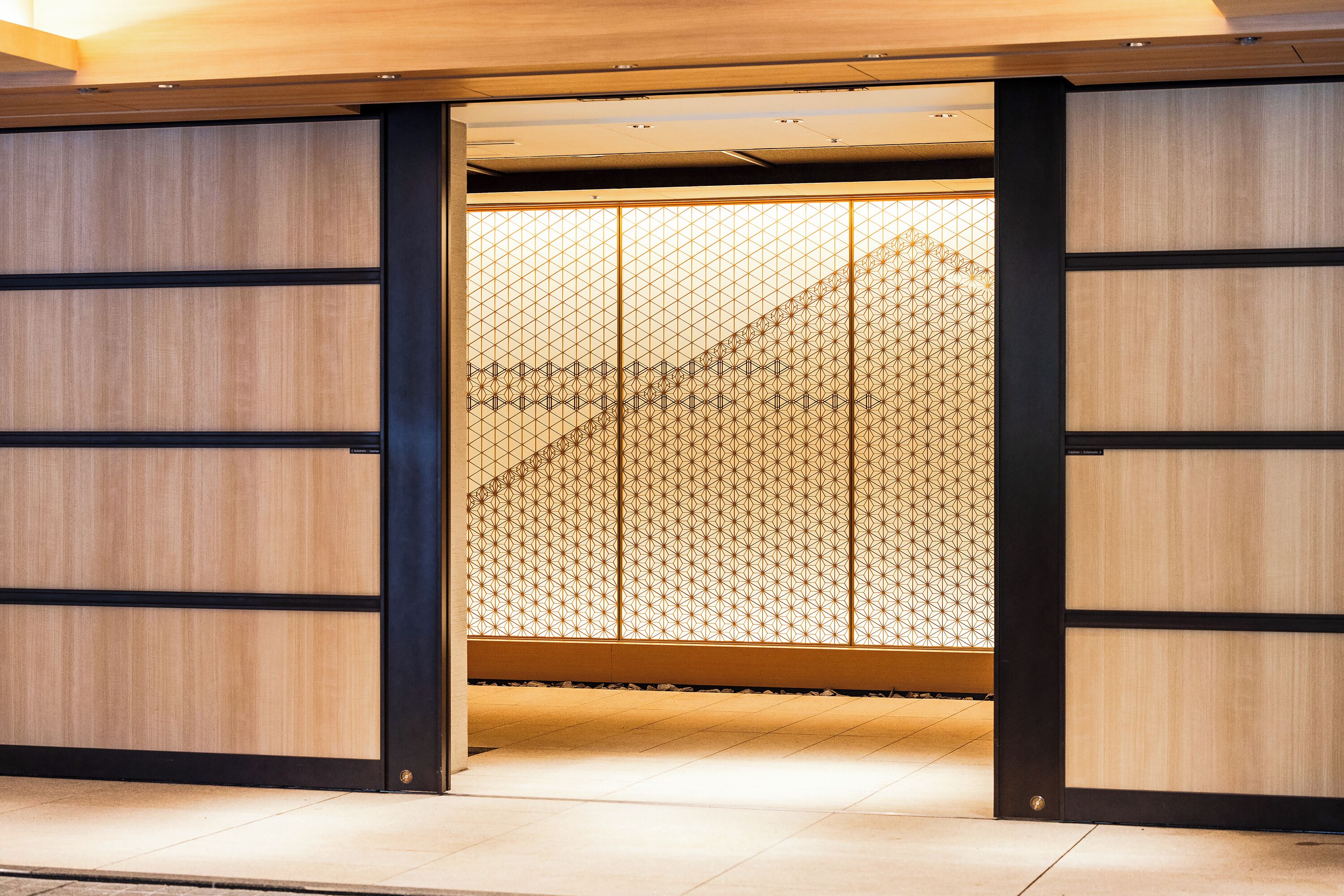 A traditional Japanese room with sliding doors and tatami flooring.