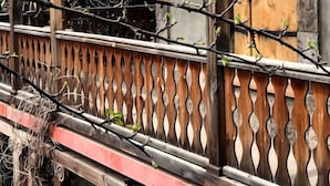 A wooden bridge with a decorative railing and a wooden door with a metal latch. - Villa Kars (Gyumri)