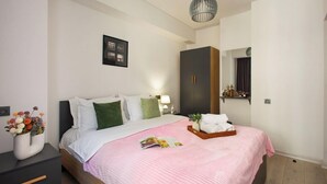 A modern hotel room with a bed, bedside table, lamp, and a large wardrobe. - Stay Inn on Pushkin Street 43 (Yerevan)
