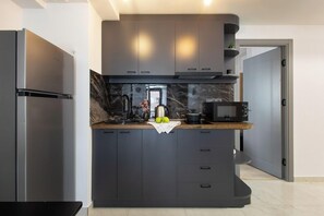 Executive Apartment, 1 Bedroom | Private kitchen | Fridge, microwave, coffee/tea maker, electric kettle