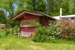 Relax in a serene natural setting surrounded by lush greenery and vibrant flowers.