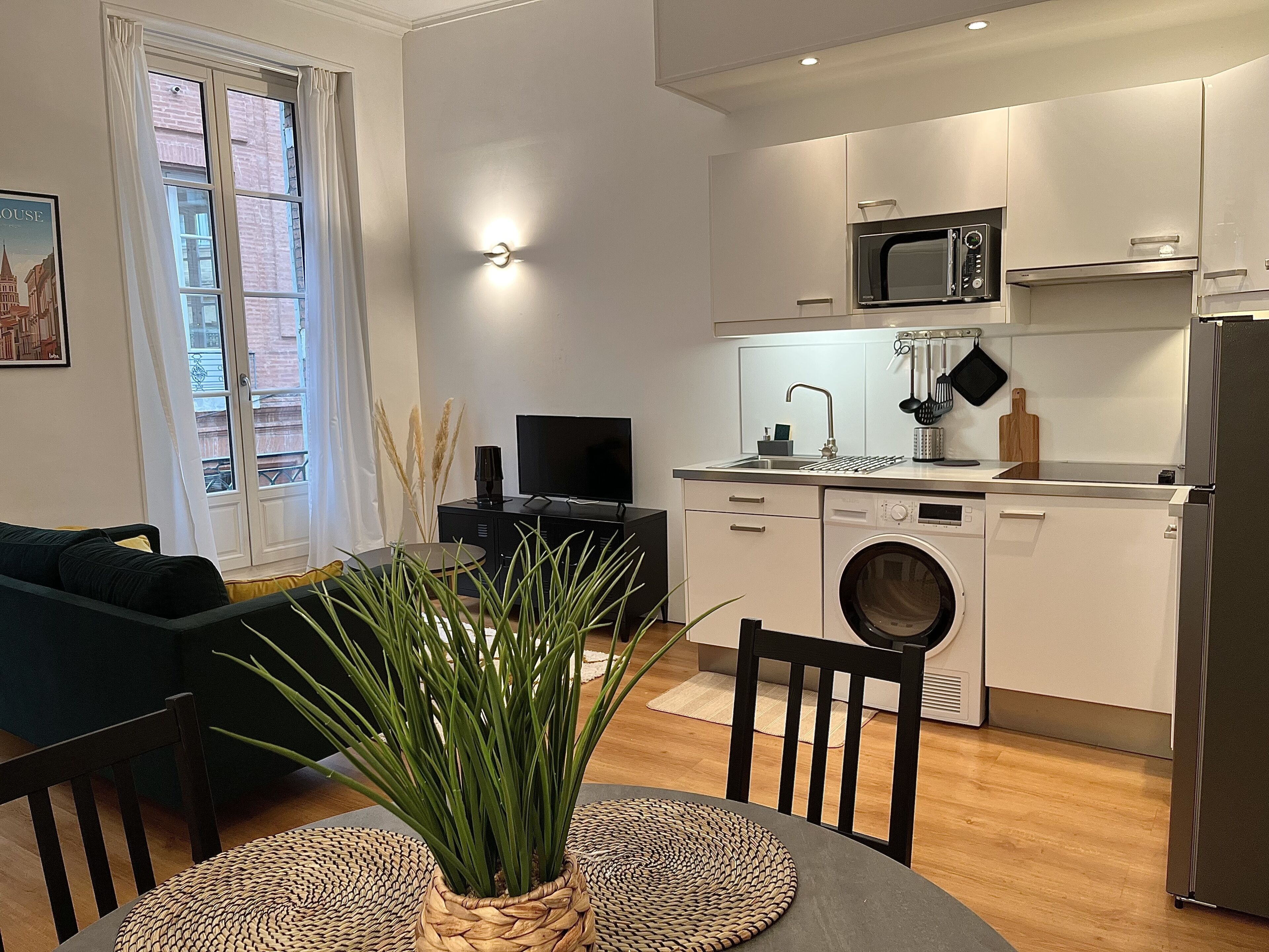 A modern apartment with a living room, dining area, and kitchen.