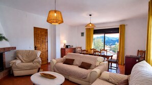 A living room with a sofa, armchairs, a small table, and a fireplace. - Torcal 1 - Magnificent Villa for 8 People, Heated Pool, A/C, WIFI, Pet friendly! (Comares)